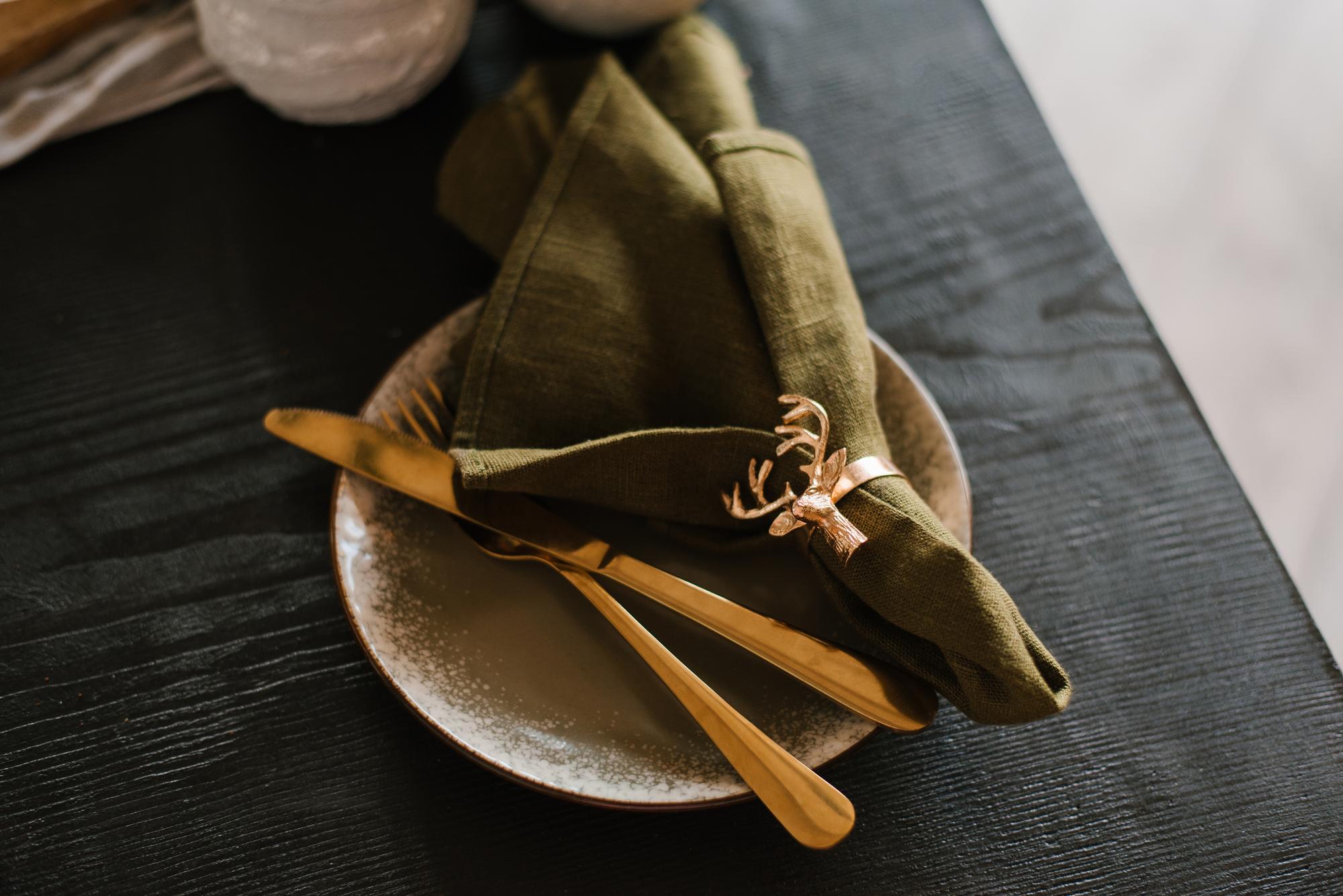 set of plated courses on linen with brass cutlery